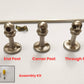 Brushed nickel gallery rail components showing end post, corner post, through post types, mounting screws, and assembly kit.
